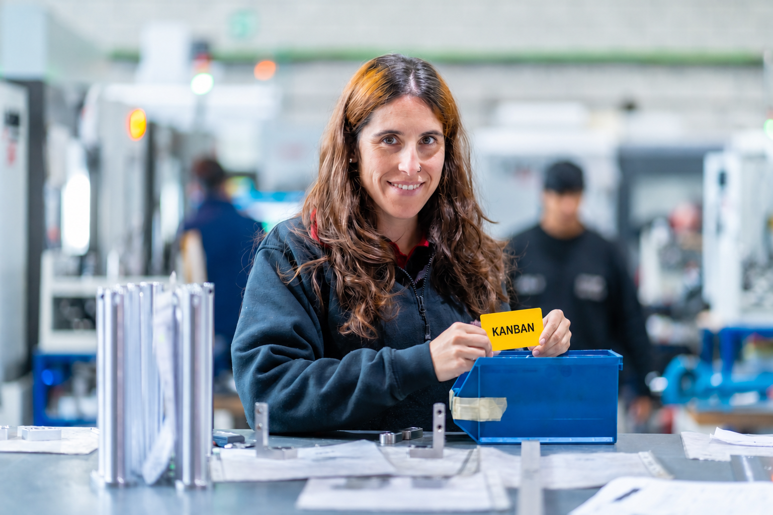 Kanban-card Woman holding a Kanban card, indicating the end of the stock and to reorder to items