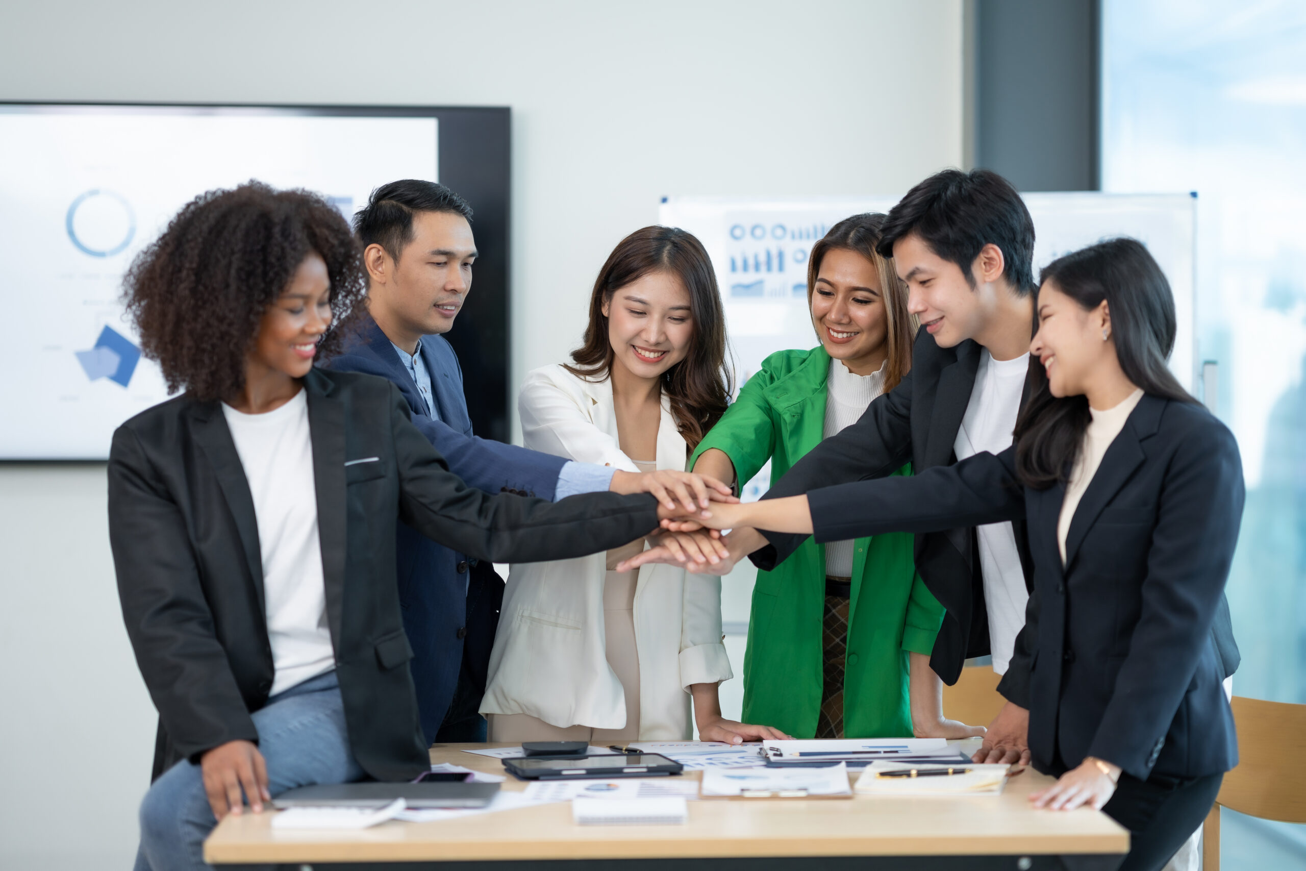 Problem Solving with Lean Principles Young Asian business people shaking hands to agree to work towards the same goal and work together as a team on a new start-up project. Unity and Teamwork Concept